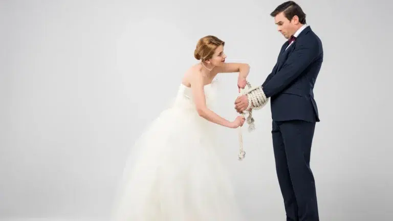 bride-in-wedding-dress-binding-groom-with-rope